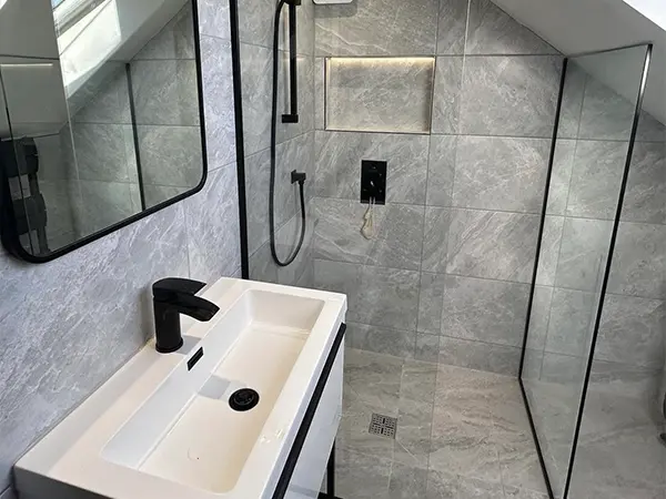 Small bathroom with grey tiles and white sink