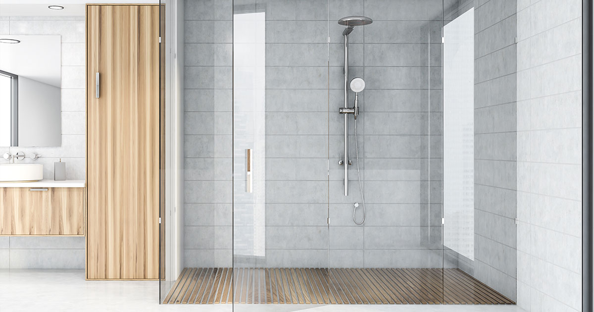 Modern spacious shower with tiles and wood accents.
