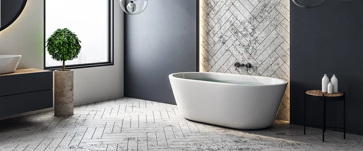 Grey and black spacious bathroom with tub and window.
