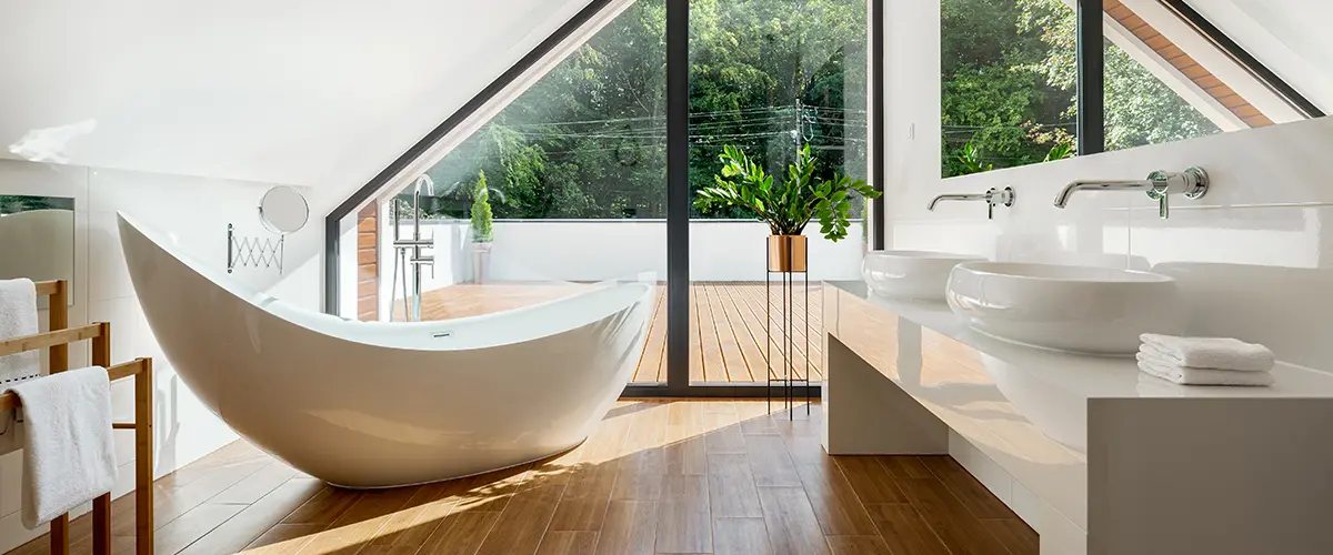 Elegant bathroom remodeling with a freestanding bathtub, large windows, and minimalist design for a luxury spa-like experience.