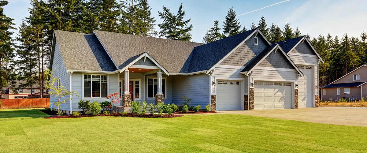 Beautiful single-story suburban home with a large green lawn, front porch, and modern architectural design.