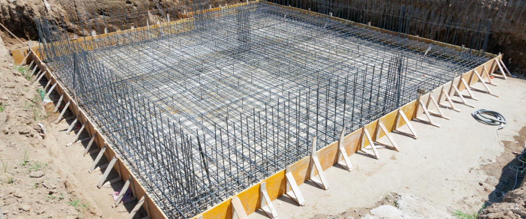 Concrete foundation with a dense rebar grid at a construction site