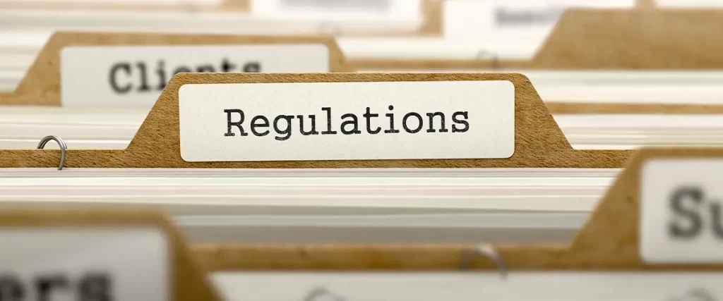 Close-up of file folder labeled “Regulations” in an office filing system for compliance and legal documentation