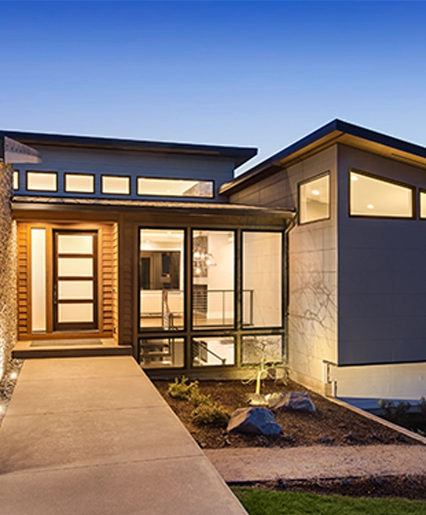 Beautiful modern home building in La Mirada with sunset with glowing interior lights