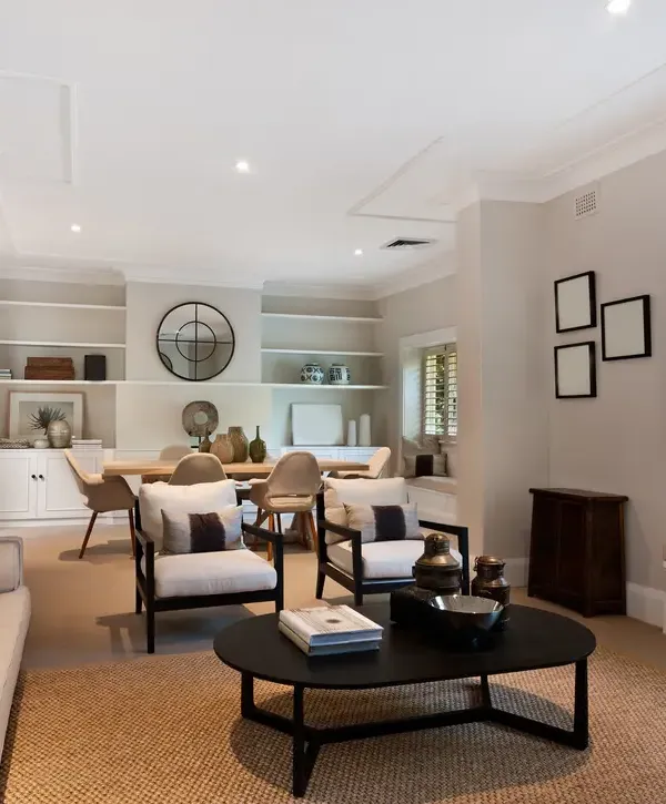 A beautifully staged open-concept living and dining room featuring neutral tones and modern furniture, showcasing professional home improvements in Bellflower, CA.