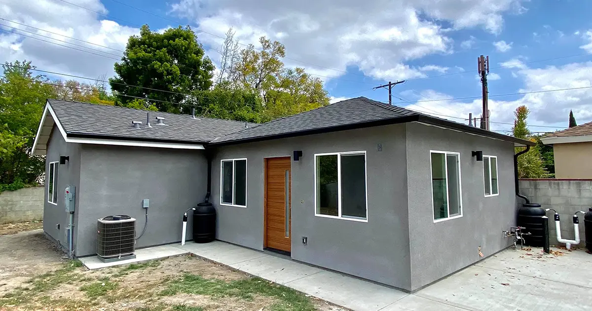 Modern ADU construction with stucco exterior, energy-efficient windows, and contemporary design