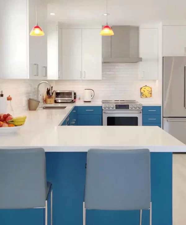 Remodeled kitchen with white and blue cabinets and wood flooring